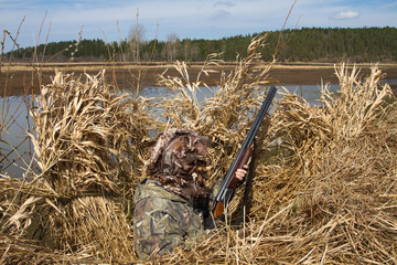 Wall Mural - duck hunter sits in shelter during the hunt