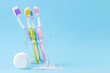 Oral hygiene. Toothbrush, dental floss and toothbrush sticks on a gentle blue background. space for text