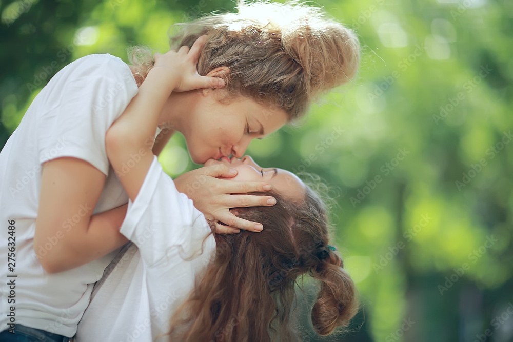 Daughter Kisses Mom Happy Family Mom And Daughter Kiss Concept Of daughter-kisses-mom-happy-family-mom-and-daughter-kiss-concept-of