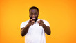 © motortion - Confident afro-american man pointing fingers camera, choice gesture, flirt sign