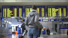 Man Traveler Looking At Time Table In Train Station, Preparing For Departure