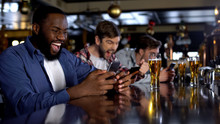 Emotional African-american Male Celebrating Winning Bet On Match, Bookmaker App