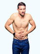 © Krakenimages.com - Handsome shirtless man showing nude chest with hand on stomach because nausea, painful disease feeling unwell. Ache concept.