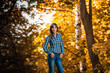 © solstizia - beautiful woman in autumn in  red forest walks