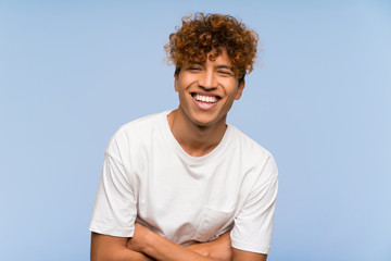 Wall Mural - Young african american man with white shirt laughing