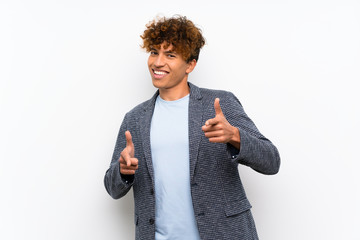 Fashion african american man over isolated white wall pointing to the front and smiling