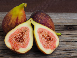 Wall Mural - Fresh fruit figs on old boards, cut one of them in half