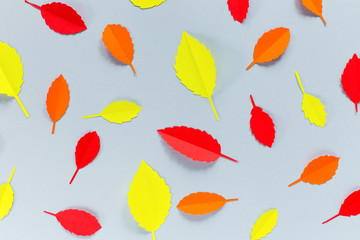 Wall Mural - autumn leaves of paper on a gray background