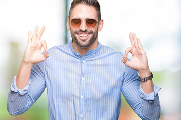 Young handsome man wearing sunglasses over isolated background relax and smiling with eyes closed doing meditation gesture with fingers. Yoga concept.