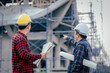 © EKKAPON - Engineers, construction sites, two businessmen Engineering objects in the workplace with architectural plans Draft construction project