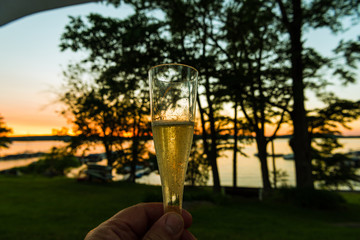 Champagne toast with sunset background