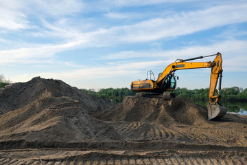 excavator is standing on the sand