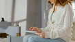 © motortion - Female using digital tablet at home, chatting in social networks with friends