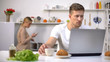 © motortion - Couple using gadgets in kitchen, ignoring live communication, addiction concept