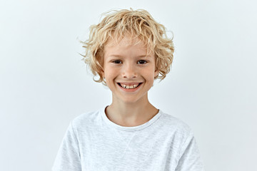 little child boy portrait against white background. laughter and joy emotions