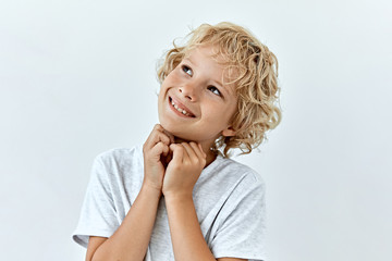 Wall Mural - Dreamy,pleased, thinking emotion . Wish concept. Little blonde boy face portrait on white backgound.