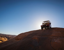 Group Of People Riding In Off-road Vehicle On Desert Trail In Moab, Utah