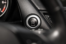 Car Engine Push Start Stop Button Ignition Remote Starter. Car Dashboard:  Black Engine Start Stop Button, Car Interior Details. Soft Focus