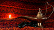 Old Arabic lamp with smoke, magical Aladdin lamp closeup over dark background. Arabic objects over Warm fabric. Middle east elements. Ramadan Background. Islamic background. Arabian Nights.