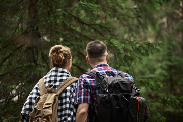 Couple looking at the green deep forest