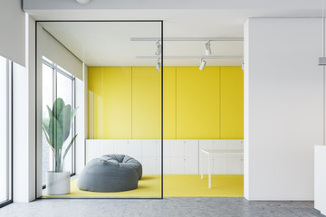 Yellow and white office waiting room with pouffes