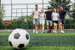 © Тарас Нагирняк - Happy friends  preparing kicking football on the sports field during soccer match..