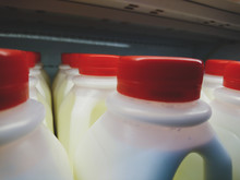 Milk In Plastic Bottles With Red Caps.