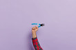 © wayhome.studio  - Mans hand holds pliers with blue plastic handles for construction and repair, isolated over purple background. Pointy nose pliers in hands of engineer or handyman. Hand tool. Symbol of hard work