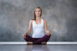 © Viktor Koldunov - Caucasian woman practicing yoga, doing sukhasana or easy seat pose, working out. Indoor full length studio shot