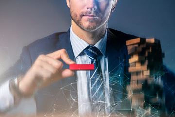 business man try to build wood block on wooden table and black background business organization startup concept