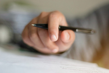 Hand holding the mouth on the document.