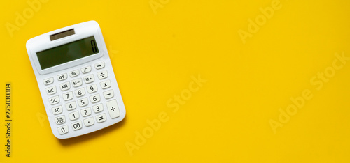 Fotografía close up white calculator on yellow background for business financial concept