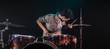 © puhimec - musician playing drums with splashes, black background with beautiful soft light