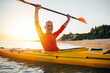 © yossarian6 - Smiling senior kayaker enjoy kayaking on sunset sea