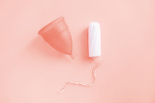 Reusable Menstrual Cup And Tampon Toned With Main Trendy Living Coral Color Of The Year 2019, Concept Female Intimate Hygiene Period Products And Zero Waste. Flat Lay, Top View. Copyspace