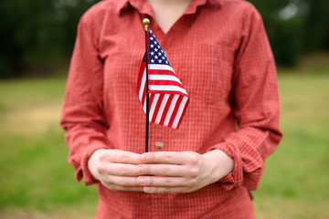 Young woman holding american flag. Independence Day concept.