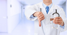 Doctor Hands Holding A Water Glass With Thumbs Down