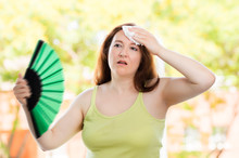 Woman Fanning And Sweating Suffering A Heat Stroke