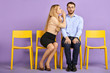 © alfa27 - pretty blonde young woman whispering secret in ear to young man in round glasses who seems to be amazed and shocked and waiting for job interview