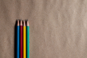 Many colorful pencils on brown paper can be applied to designs.