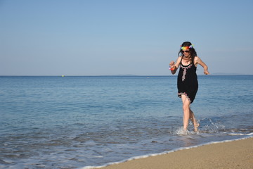 Joyful Woman Running On Edge Of The Sea. Summer Vacation Concept, Single Woman Enjoy At Beach