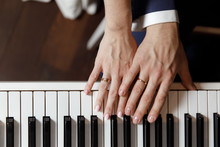 Groom And And Bride Hands With Rings. On Piano, Close Up