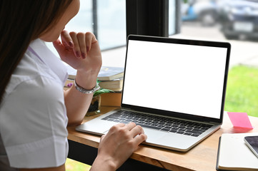 Young woman working with mockup laptop computer.