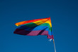 © 19b_production - LGTBQ Flag on the blue sky. Rainbow flag over the Barcelona during Pride parade.