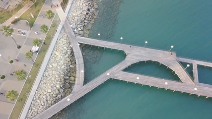 Wall Mural - Aerial top down view of Limassol promenade and pedestrian sea bridge