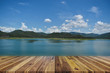 Perspective empty wood table on top over dam and mountain with blue sky in background. For products display or design layout.