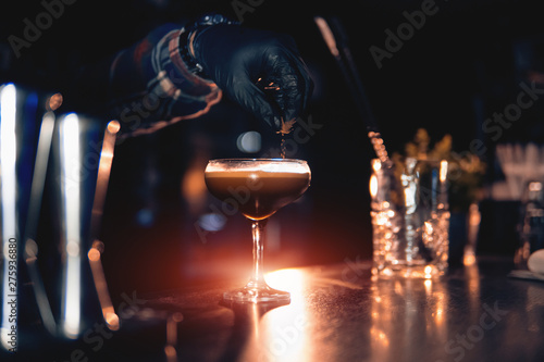 Cuadros en Lienzo elegant glass with espresso martini cocktail on blue background