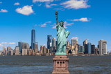 Fototapeta  - The Statue of Liberty over the Scene of New york cityscape river side which location is lower manhattan,Architecture and building with tourist concept