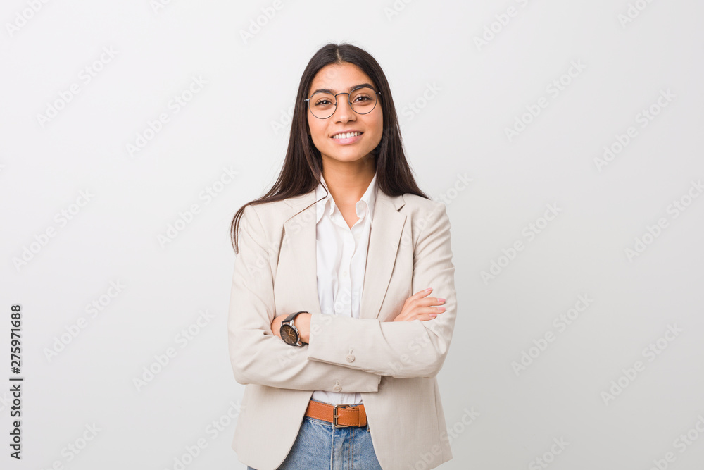 Young business arab woman isolated against a white background who feels confident, crossing arms with determination. - obrazy, fototapety, plakaty 