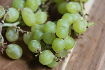 bunch of fresh White grapes on wooden background